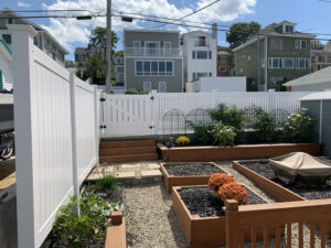 a new vinyl fence installed around a garden at a family home