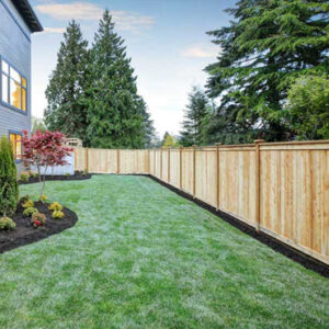 a newly installed wood fence surrounding a residential yard